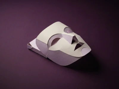 Paper mask crafted from layered light pink and cream cardstock on a dark purple background, abstract and minimalist art piece.