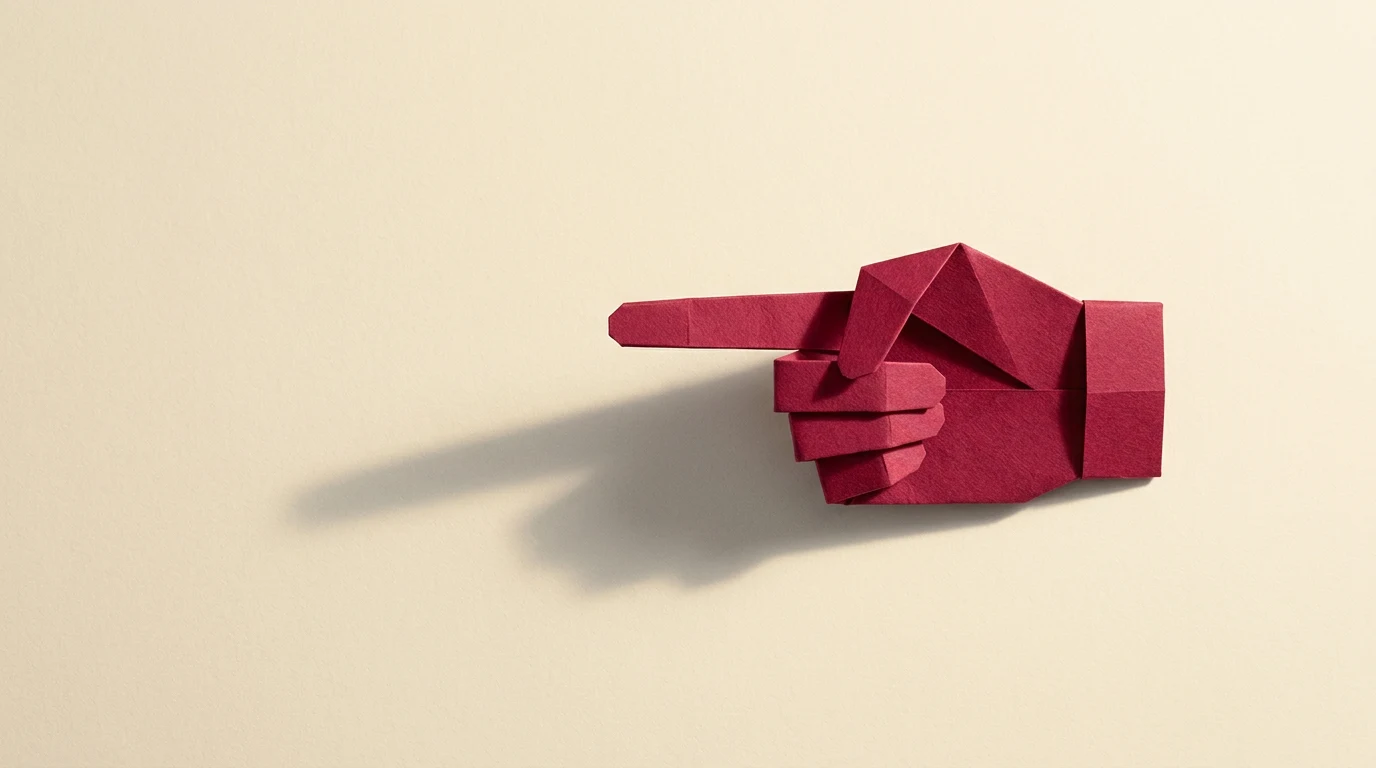 Funkcja impresywna po czym ją poznać przykłady i różnica wobec perswazyjnej - Promptowy Red origami hand with index finger pointing to the left on a beige background, with a soft shadow