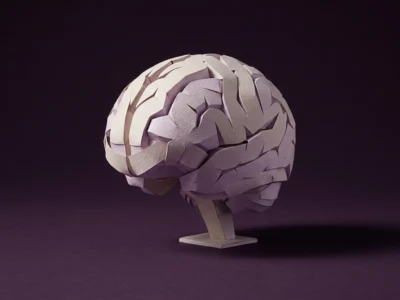 Paper brain sculpture on a stand against a dark purple background, resembling a neuroscience model.