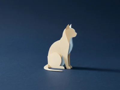 Cream paper-cut dog sculpture sitting on a dark blue surface.