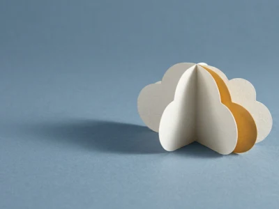 Satya Nadella człowiek który wprowadził AI do Microsoftu - Promptowy 3D paper cloud sculpture with white and orange layers on a blue surface, photo of a crafts project.