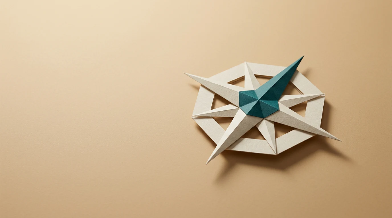 Geometric paper star sculpture with white spokes and a teal center on a beige background.