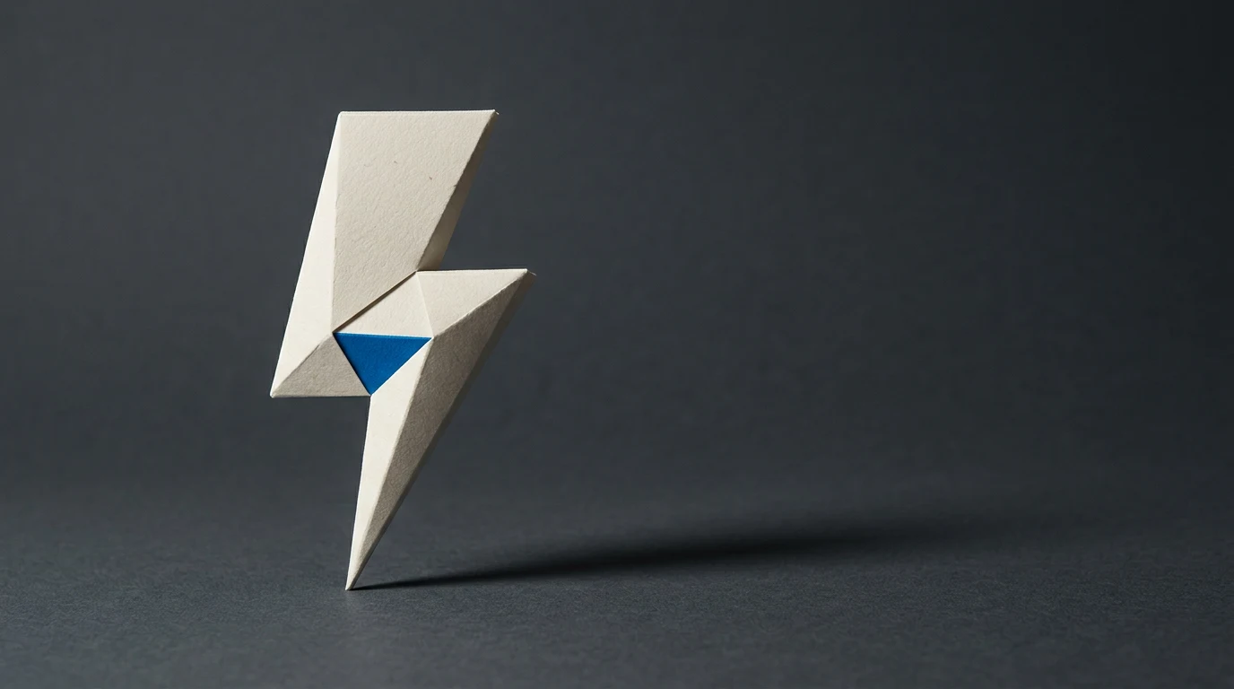 Abstract geometric origami sculpture in white paper with a blue inner triangle on a dark surface.