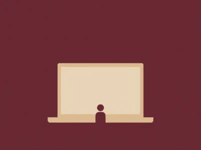 Silhouette of a person sitting in front of an open laptop on a maroon background.